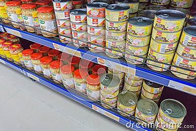 Various tinned foods and vegetables preserved in jars display on shelves in a supermarket, Editorial Stock Photo