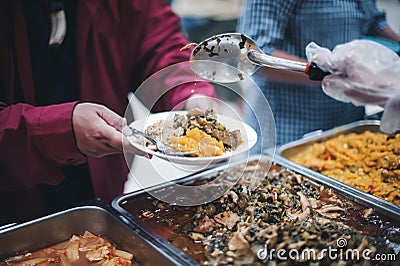 Food support for the poor, homeless hands submitting free food from volunteers Stock Photo