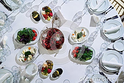 Food table with various dishes, snack food, fresh vegetables, top view Stock Photo