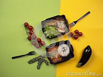 Food in takeaway box: rice with fish in sauce, chicken with buckwheat, vegetables and green salad. Stock Photo
