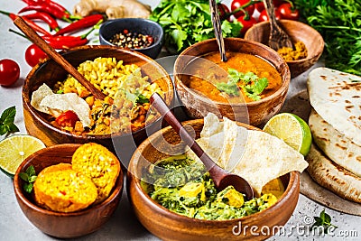 Food traditional Indian cuisine. Dal, palak paneer, curry, rice, chapati, chutney in wooden bowls on white background Stock Photo