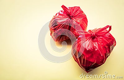 Food trash packing in red plastic bag on color background. Recycle and environment Stock Photo