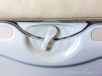Food tray and drink rack rear passenger seat on airplane. Stock Photo