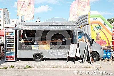 Food truck selling fast food and drinks parked in street in summer Editorial Stock Photo