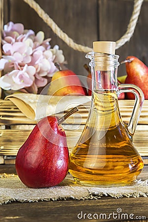 Food, vegetarianism, healthy diet food, drink. Natural juice without pulp from fresh red pear in a glass decanter, wine, liqueur Stock Photo