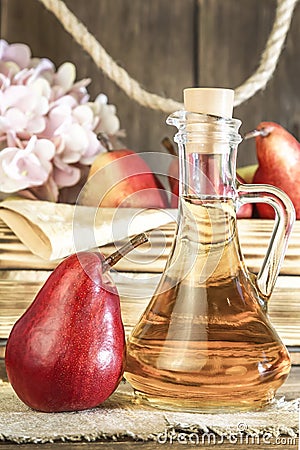 Food, vegetarianism, healthy diet food, drink. Natural juice without pulp from fresh red pear in a glass decanter, wine Stock Photo