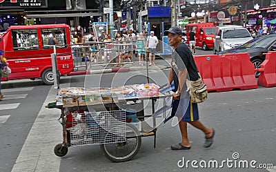 A food vendor walks the colourful streets of Thailand`s Phuket Editorial Stock Photo