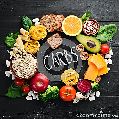 Foods high in carbohydrates: bread, pasta, avocado, flour, pumpkin, broccoli, beans, spinach. The concept of healthy eating. Stock Photo