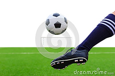 Foot kicking soccer ball Stock Photo