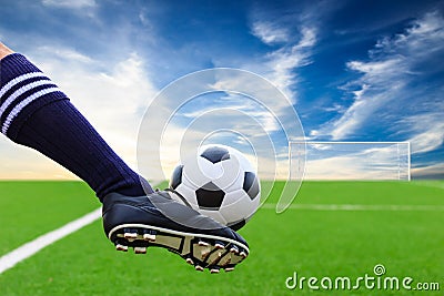 Foot kicking soccer ball Stock Photo