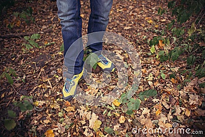 Foot Man walking on fall in the park on autumn leaves. Lifestyle Stock Photo