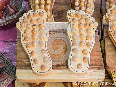 Foot massage is handcrafted from wood. Stock Photo