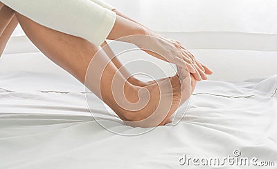 Foot massage in old women Stock Photo
