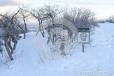 Foot path and signages at the snow covered slope of Wasatch Mountains in winter Stock Photo