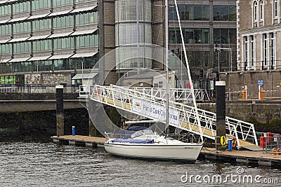 A 40 foot seagoing yacht moored to a floating deck at the entrance to the Port of Cork City Marina in the Republic of Ireland Editorial Stock Photo
