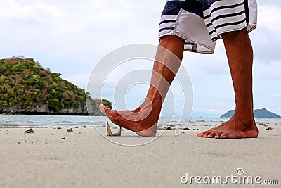 Foot stepping on broken glass. Stock Photo