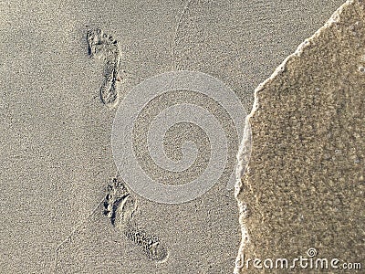 Foot Steps Prints On Ocean Beach Stock Photo