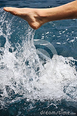 Foot of young man in water - splash Stock Photo