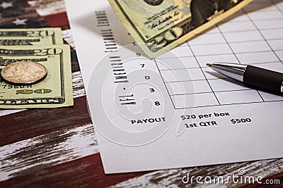 Football American office pool grid for sports betting concept with boxes, dollars, pen - blank grid Stock Photo