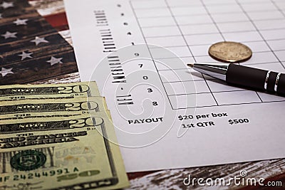 Football American office pool grid for sports betting concept with boxes, dollars, pen - blank grid Stock Photo