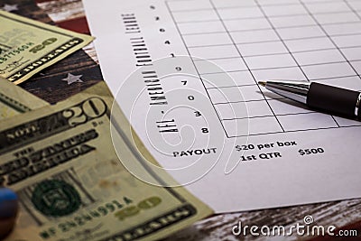 Football American office pool grid for sports betting concept with boxes, dollars, pen - blank grid Stock Photo