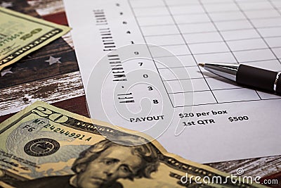 Football American office pool grid for sports betting concept with boxes, dollars, pen - blank grid Stock Photo