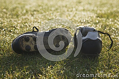 Football boots on a empty football pitch Stock Photo