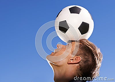 Football, bounce and head with man, sports and training with competition and exercise. Person, blue sky and player with Stock Photo