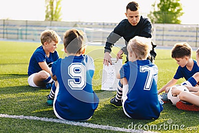 Football coach coaching kids. Soccer football training session for young boys Stock Photo