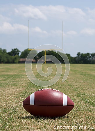 Football with the Goal Posts Beyond Stock Photo