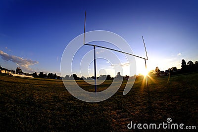 Football Goalposts Goal Posts at Sunset Sky and Bleachers Stock Photo