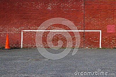 Football Goalposts, North London, England, UK - 20 March 2018 : Painted Goalpost Graffiti on Redbrick Wall with Orange Traffic Con Stock Photo