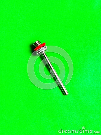 Football inflator isolated in green background Stock Photo