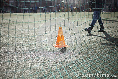 Football net on the field. Orange triangle. Stock Photo