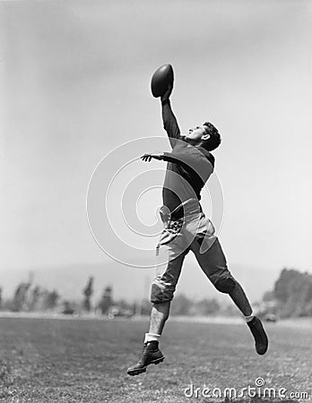 Football player catching ball Stock Photo