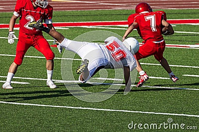 Football player diving for a tackle Editorial Stock Photo