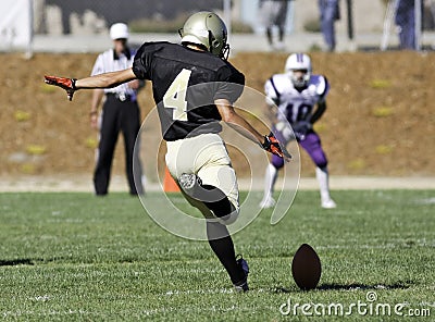 Football Player Kicking a Ball Editorial Stock Photo