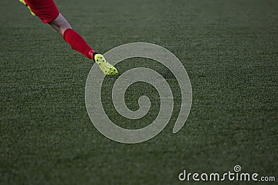The football player is shooting the football ball on artificial turf field Stock Photo