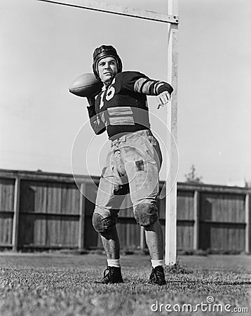 Football player throwing ball Stock Photo