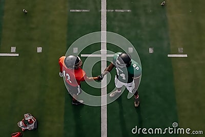 Football players shaking hands after a hard-fought competition Stock Photo