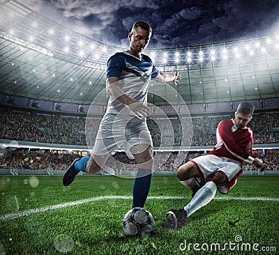 Football scene with competing football players at the stadium Stock Photo