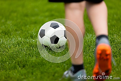 Football or soccer ball at the kickoff of a game. Soccer free kick at a grass pitch Stock Photo