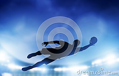 Football, soccer match. A goalkeeper jumping saving the ball from goal Stock Photo