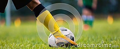 Footballer Kicking Ball Moment. Closeup of Soccer Players Leg Moving Toward Soccer Ball Stock Photo