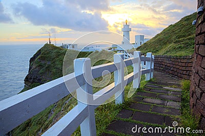 Footpath leading to a lighthouse on the cliff in northern coast of Taiwan Stock Photo