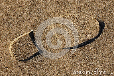 Footprint in sand on beach Stock Photo