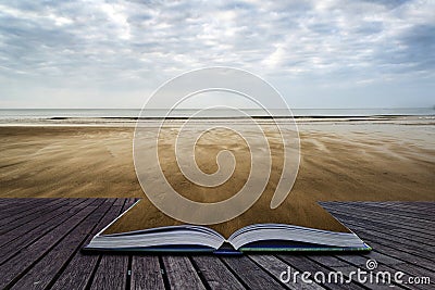 Footprints on beach Summer sunset landscape conceptual book image Stock Photo