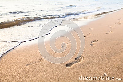 Footprints of couple walking on the beach Stock Photo