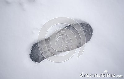 The footprints on the snow in cold winter are proof of human activity. Stock Photo