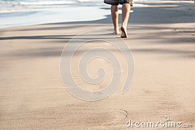 Footprints in wet sand of beach Stock Photo